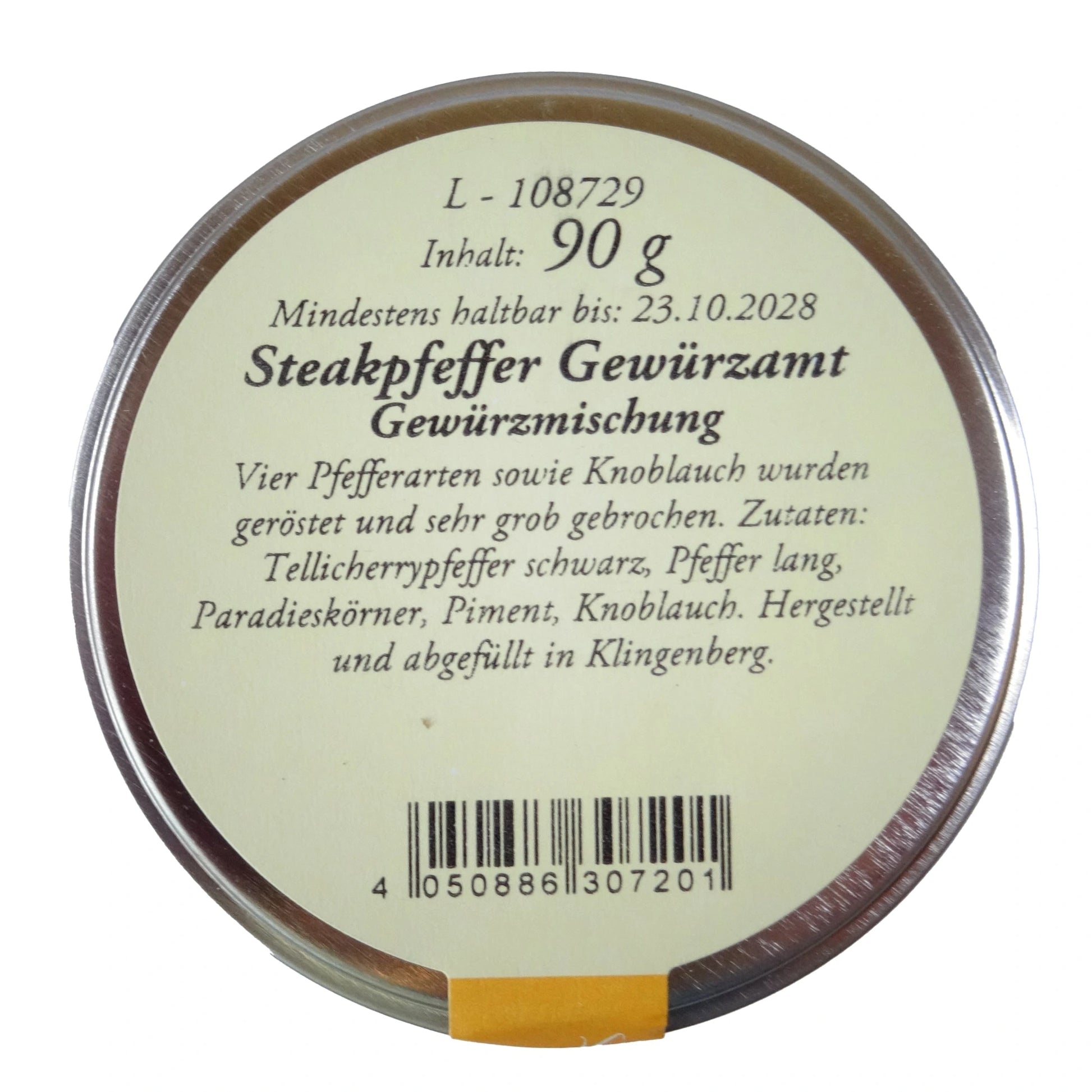 Altes Gewürzamt Steakpfeffer Grob gebrochene Premium-Pfeffermischung mit Knoblauch, grüne Gewürzdose von oben auf hellem Hintergrund