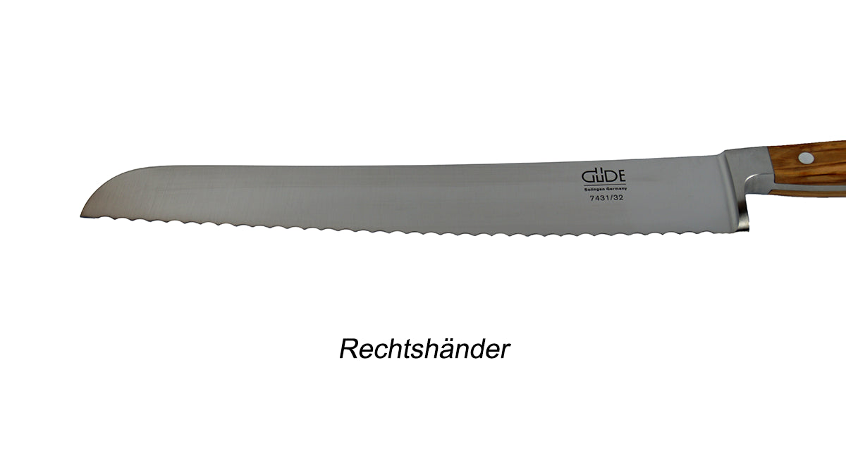 GÜDE Klinge des Brotmesser 7431/32 Alpha Olive mit 32 cm Klingenlänge und Olivenholz-Griff für Rechtshänder auf weißem Hintergrund