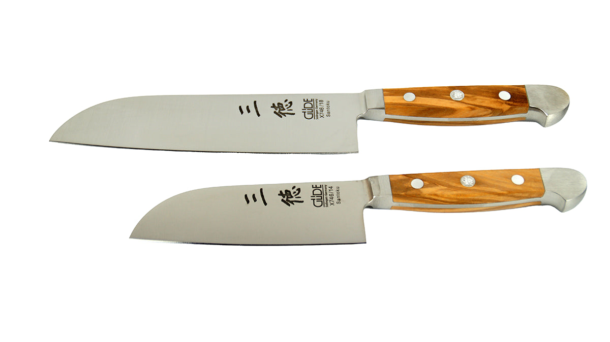 GÜDE Santoku Alpha Olive X746/14 und X746/18 – Japanisches Kochmesser mit glatter 14 cm und 18 cm langen Klinge und Olivenholz-Griff auf weißem Hintergrund