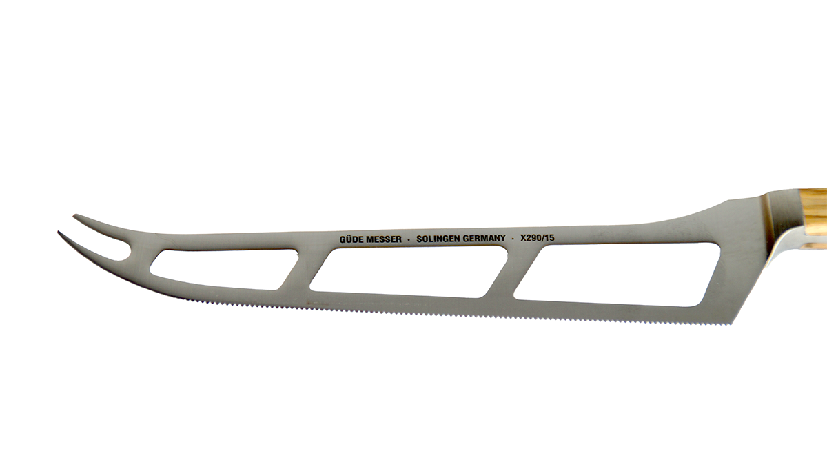 GÜDE Klinge des Käsemesser Alpha Olive X290/15 mit 15 cm Klingenlänge und Olivenholz-Griff auf weßem Hintergrund